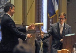 State Rep. Mark Ferrandino, right, accepts the speaker's gavel from former Speaker Frank McNulty. Ferrandino, a Denver Democrat, became the first gay man elected to position after he led a take back of the House from McNulty's Republican Party. Photo by Evan Semon/Out Front