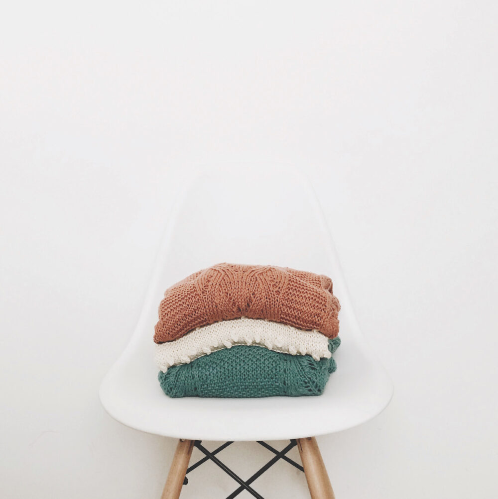 sweaters-stacked-on-chair