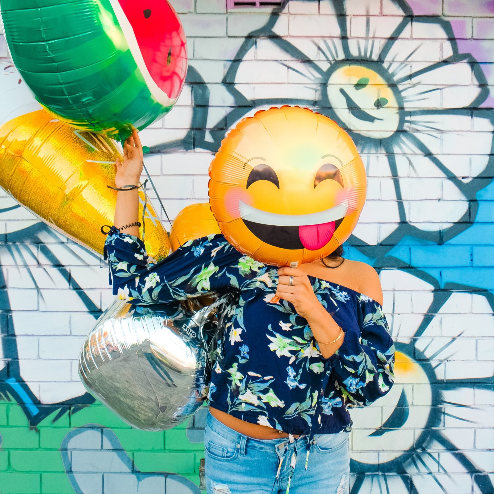 Person with happy balloon over their face