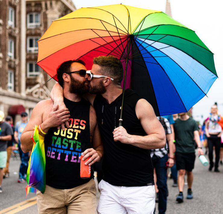 LGBTQ members kiss during the 2022 Denver Pride Parade.