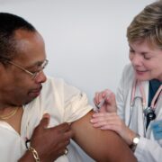 A man getting an injection from the doctor