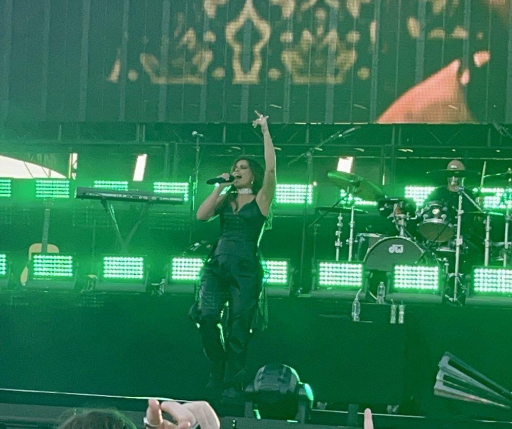 Nelly Furtado sings and points to the sky