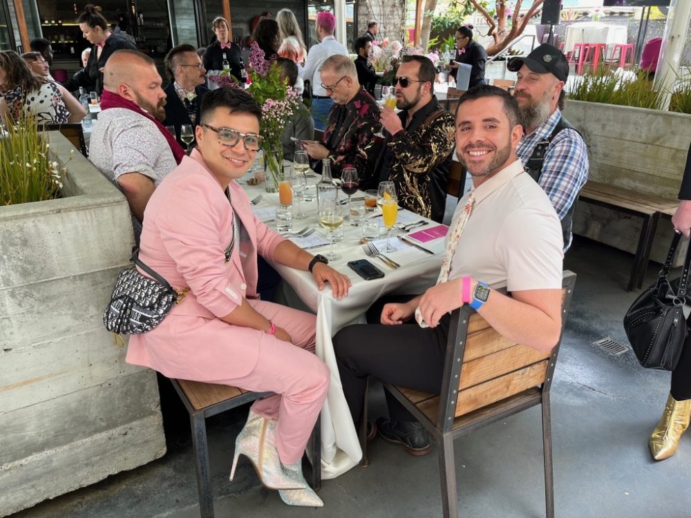 queer guests sitting at their table