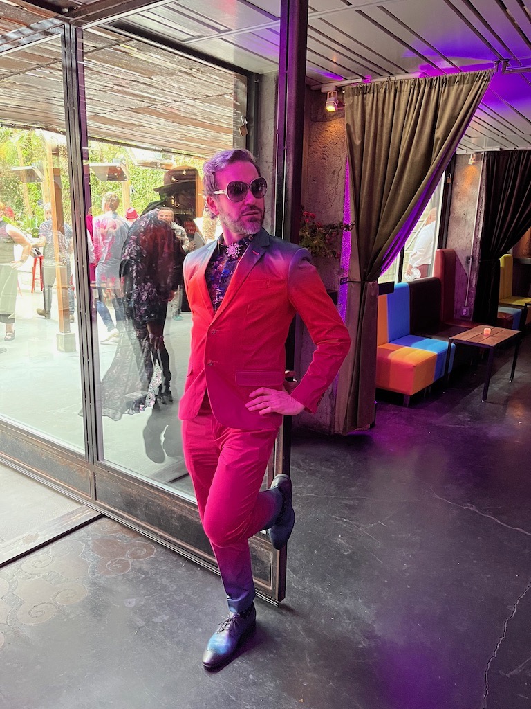 an AMAB queer in a hot pink suit