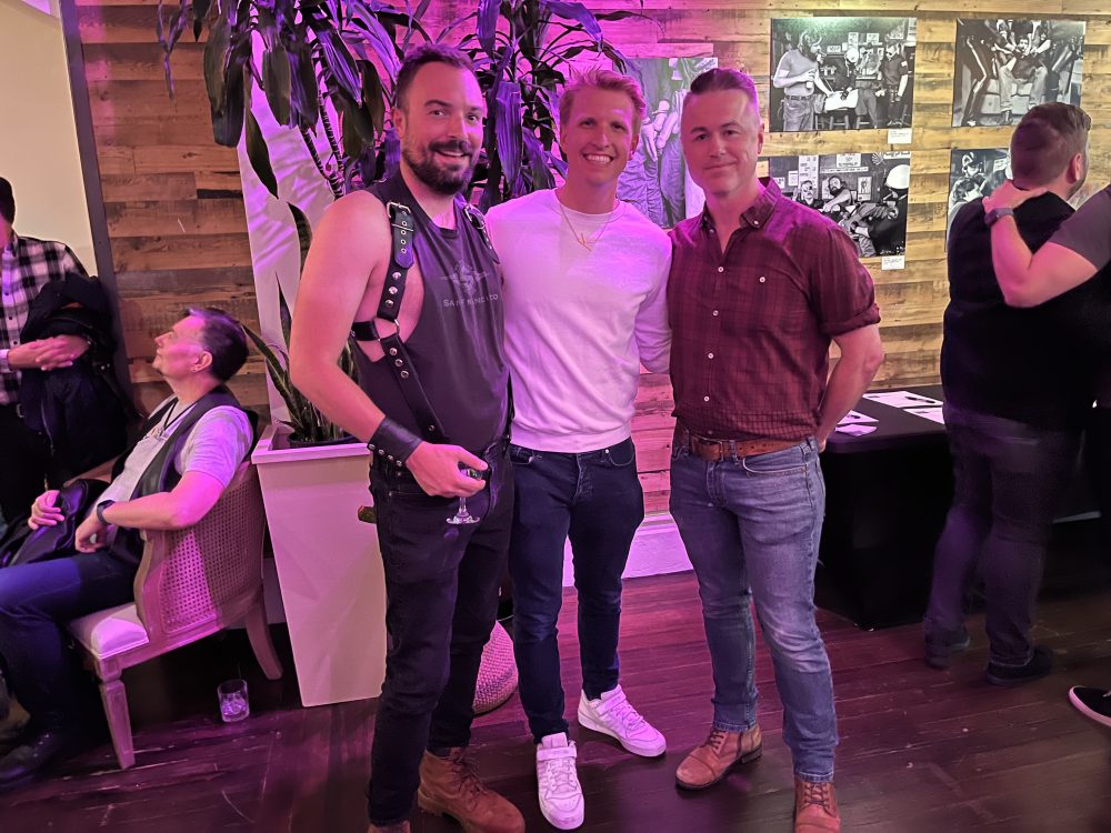 3 amab queers pose together