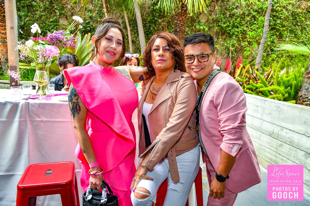 your author, and 2 queer friends pose wearing all pink