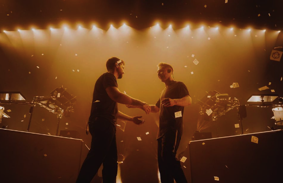 Odesza onstage shaking hands