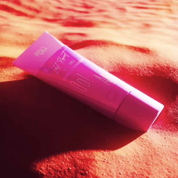 RYLO's cover art, a pink lipgloss tube laying on pink sand