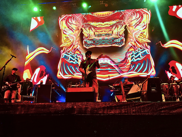 Close up on the singer of Slightly Stoopid playing and singing