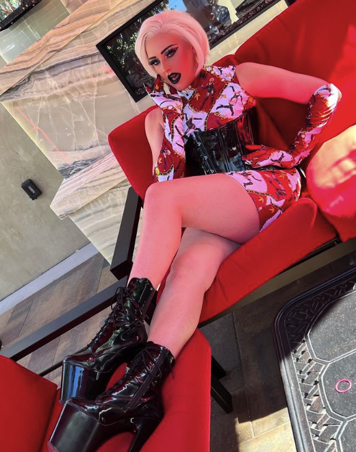 la ganja seated with platform boots propped up on a sofa