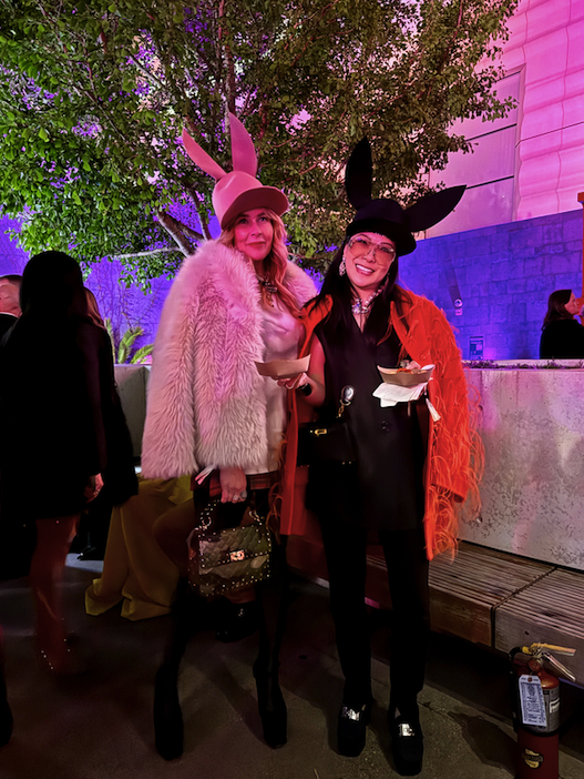 2 models wearing head to toe Valentino and signature bunny ear baseball caps