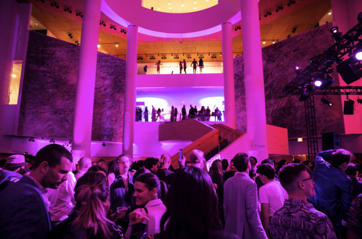 a crowd shot in the main lobby area with the grand staircase in the background