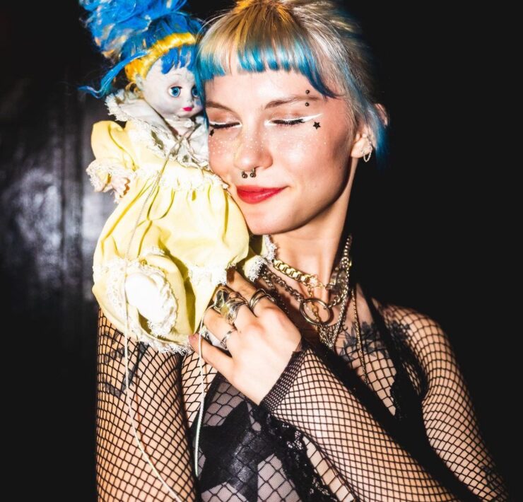 Devon Again with a doll on her shoulder