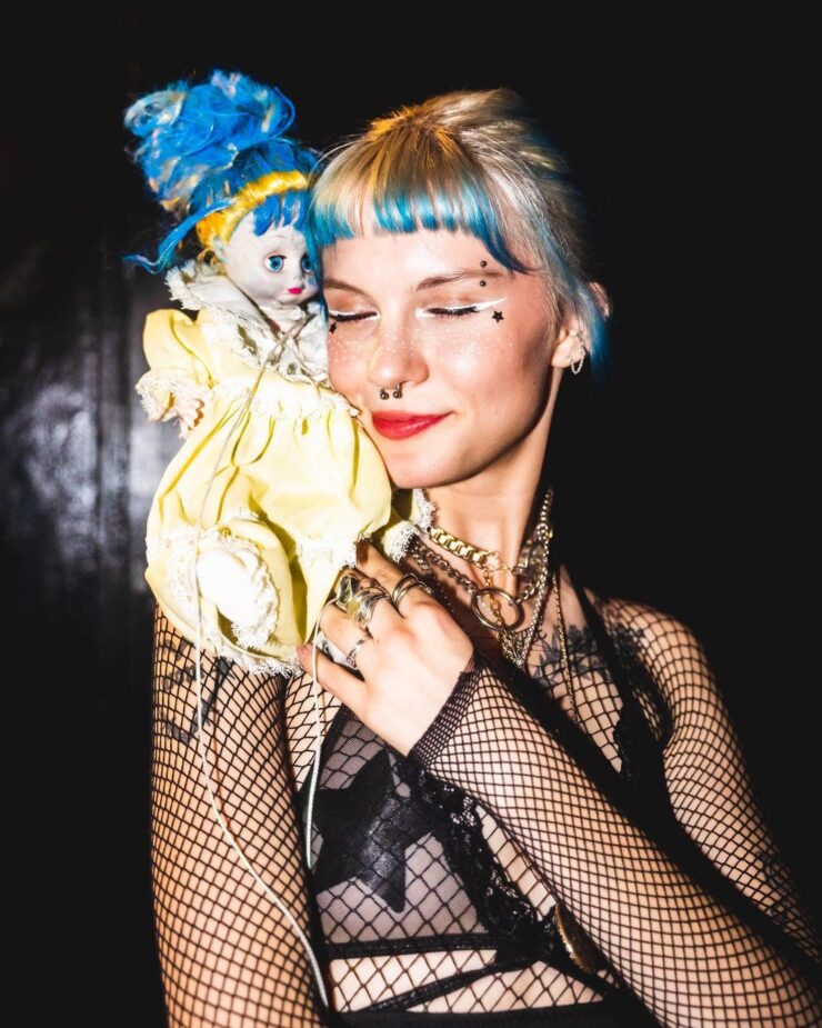 Devon Again with a doll on her shoulder