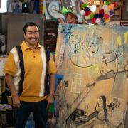Mel Dominquez with one of their paintings