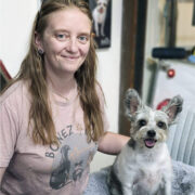 Karina Tittjung of Bonez 4 Budz poses with a small dog with large ears.