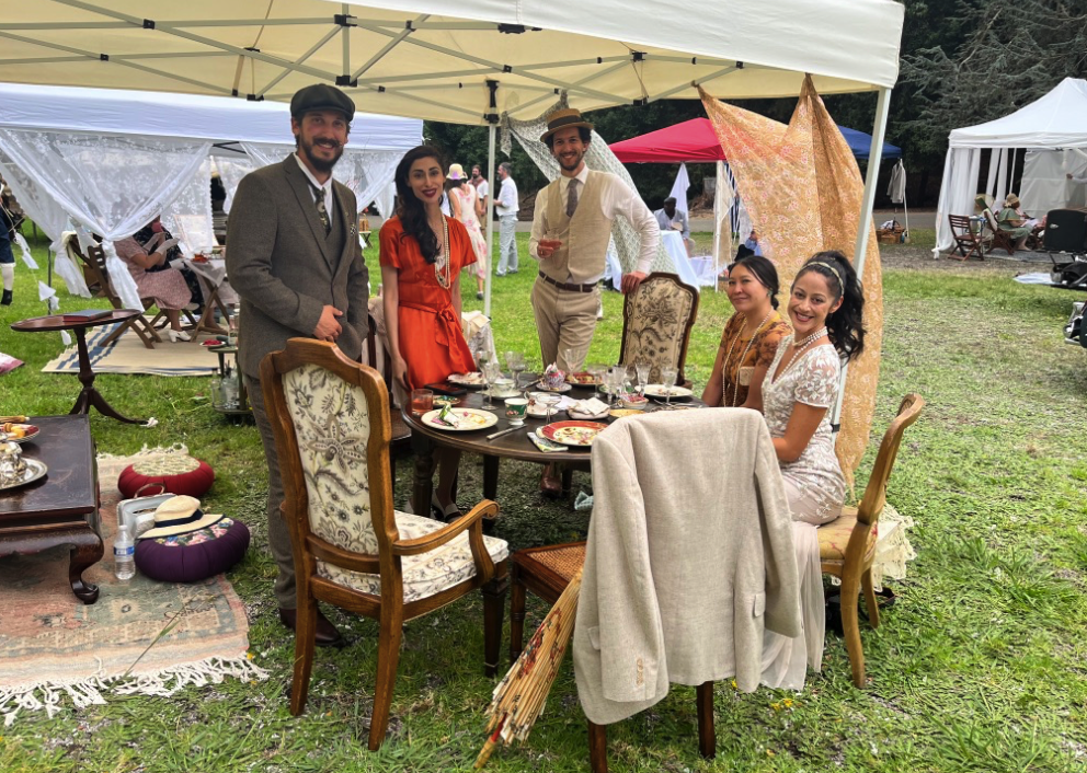a group poses with their vintage table scape