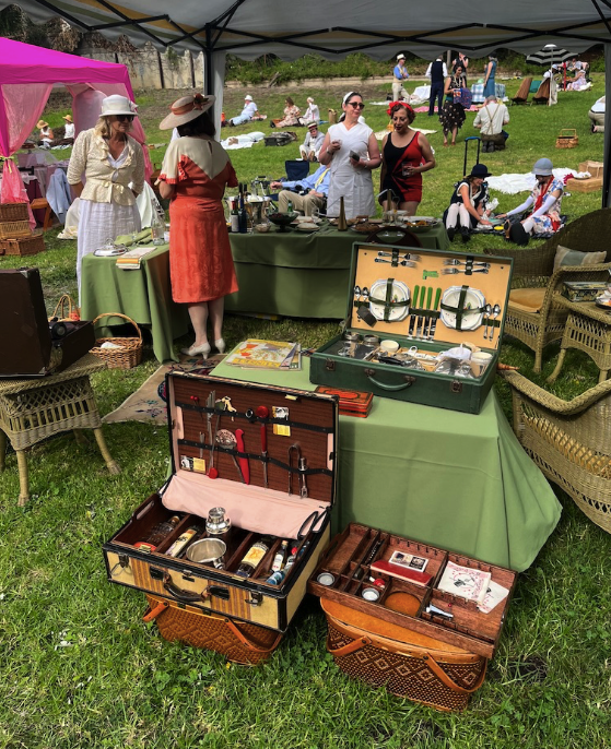 several vintage picnic baskets set up on display