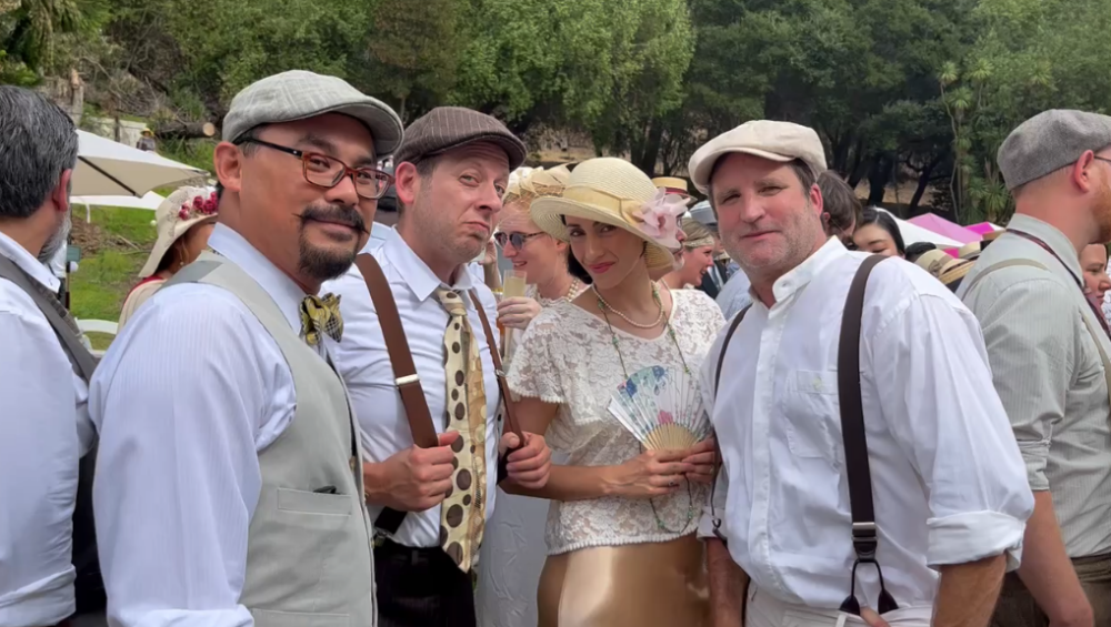 party goers, all dressed in light neutral colors