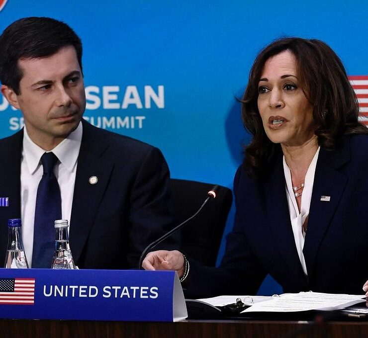Pete Buttigieg, an option for Harris' VP, sits next to her in front of a blue screen