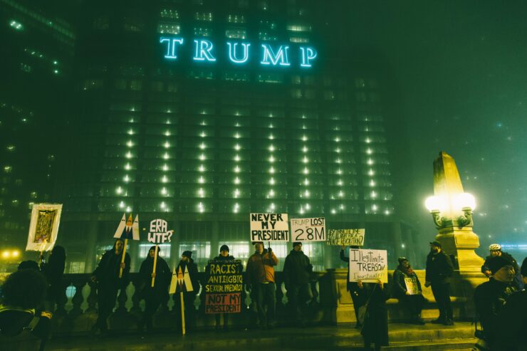 Protestors gather with signs against Donald Trump's presidency