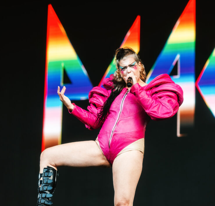 Peaches sings with one foot up on the monitor