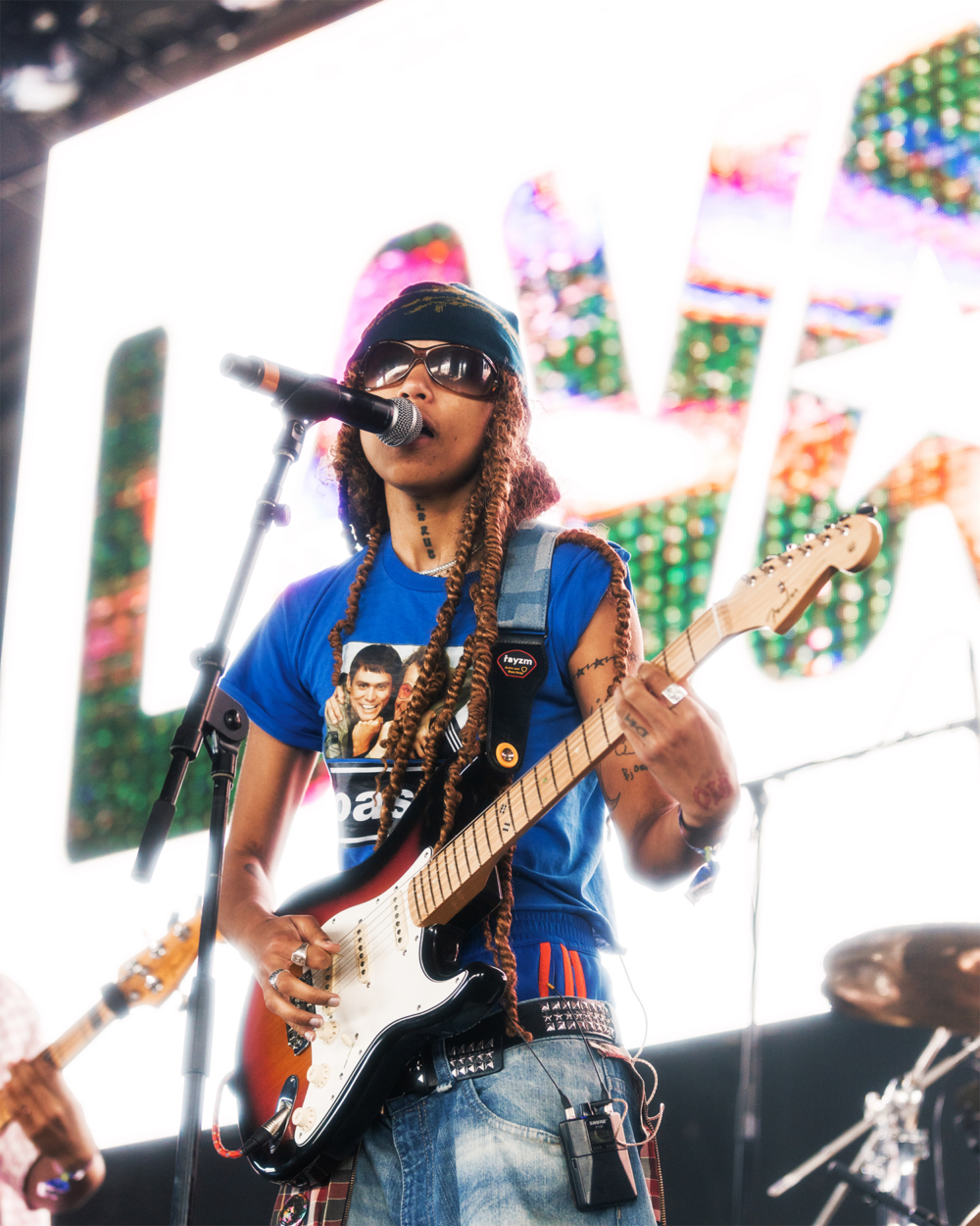 Closeup of Lava la Rue playing guitar