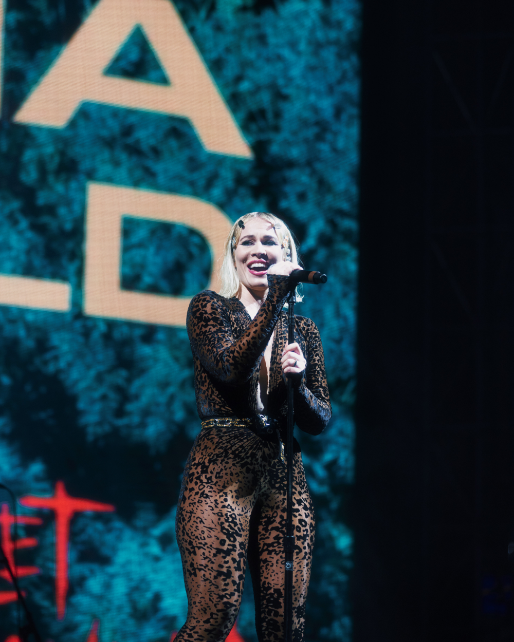 Natasha Bedingfield smiles big at the mic stand 