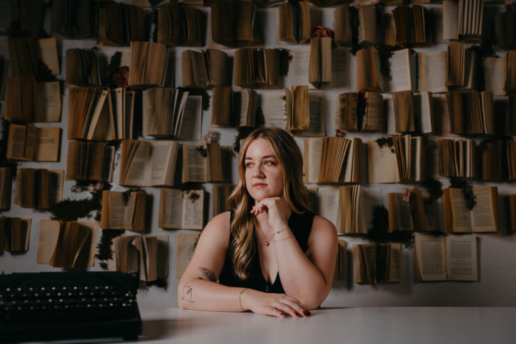Author portrait of woman in front of book wall.