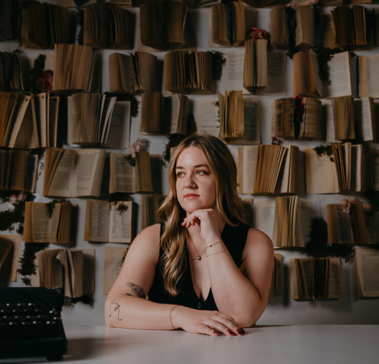 Author portrait of woman in front of book wall.