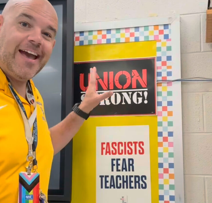 Anthony Nicodemo with Fascists Fear Teachers poster